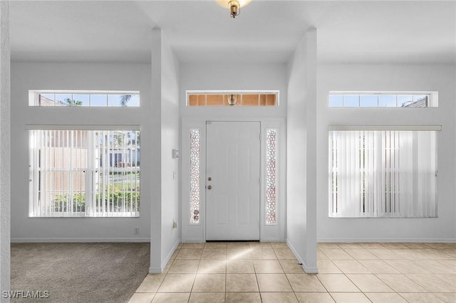 tiled foyer entrance with a high ceiling