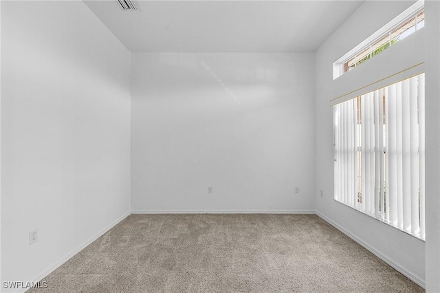 spare room with light colored carpet