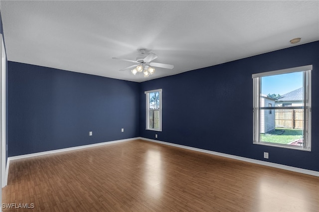 unfurnished room featuring hardwood / wood-style floors and ceiling fan