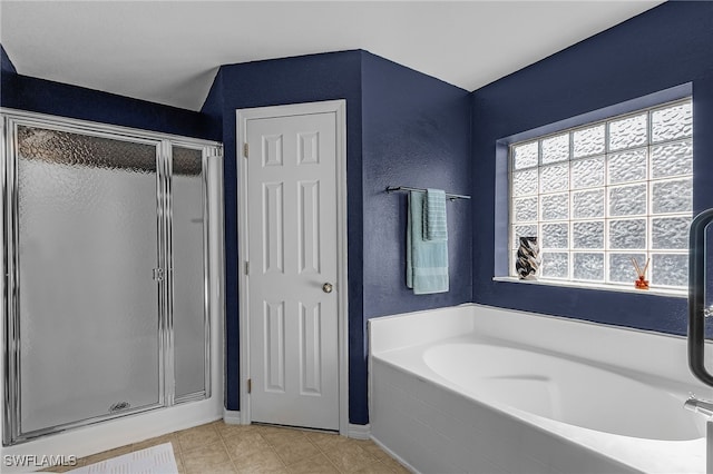 bathroom with separate shower and tub and tile patterned floors