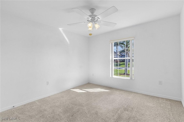 carpeted spare room featuring ceiling fan