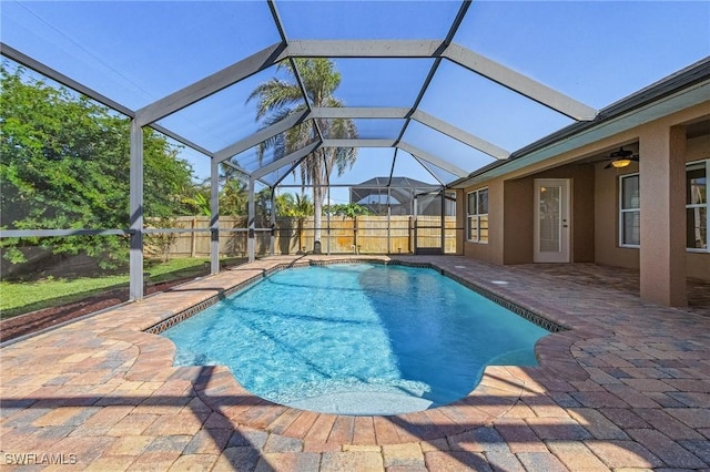 view of swimming pool with a lanai, a patio, and ceiling fan