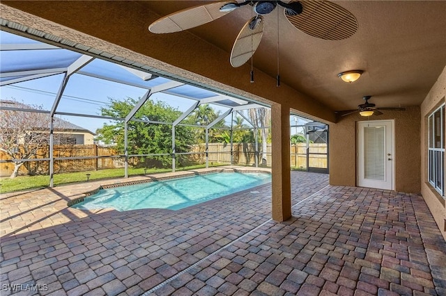 view of pool with a patio, a lanai, and ceiling fan