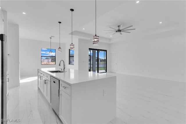 kitchen featuring white cabinetry, a kitchen island with sink, sink, and a wealth of natural light