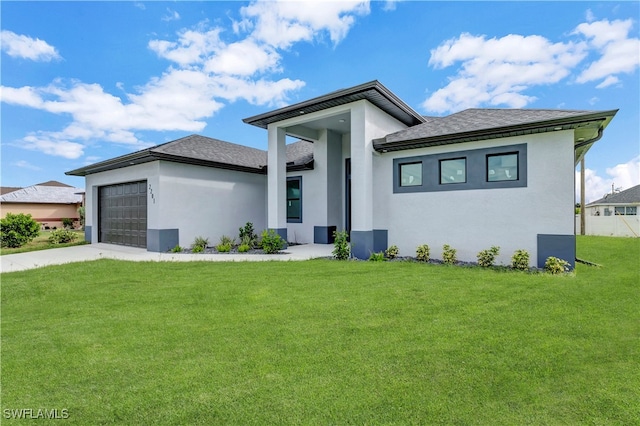 prairie-style home with a garage and a front lawn