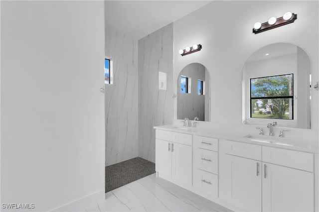 bathroom with vanity and tiled shower