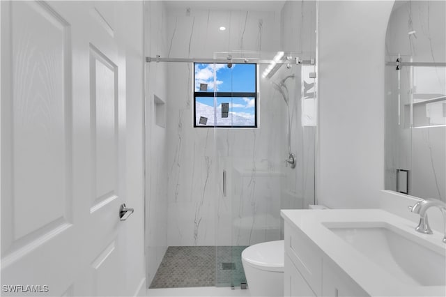 bathroom with toilet, an enclosed shower, and vanity