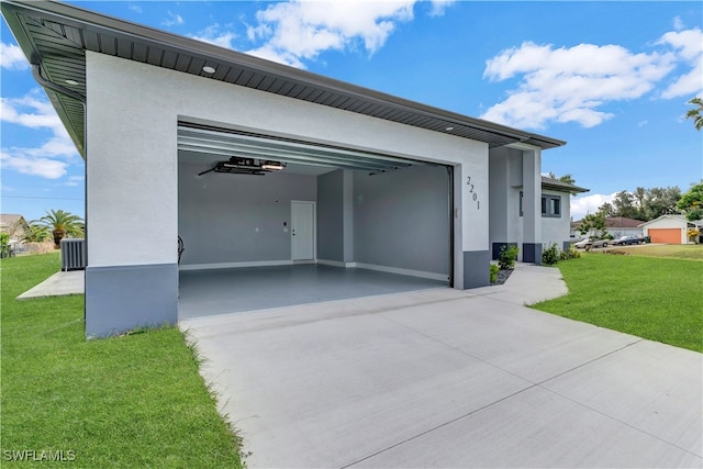 garage featuring a yard and central air condition unit