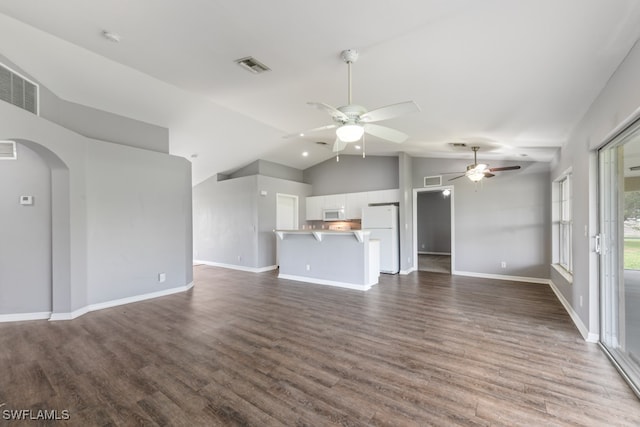 unfurnished living room with ceiling fan, vaulted ceiling, and dark hardwood / wood-style floors