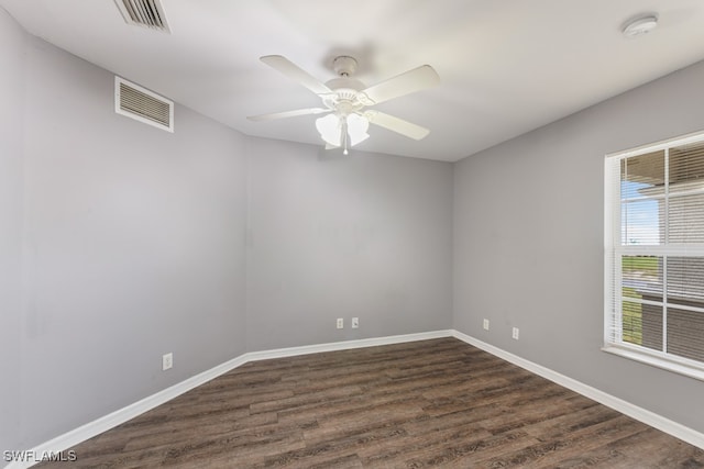 spare room with ceiling fan and dark hardwood / wood-style flooring