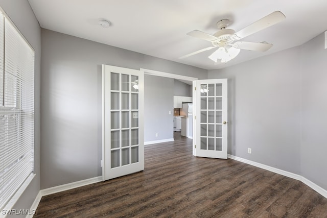 spare room featuring french doors, dark hardwood / wood-style floors, and ceiling fan