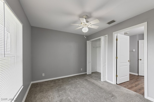 unfurnished bedroom with ceiling fan and carpet