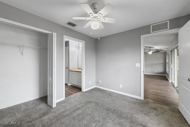 unfurnished bedroom with dark hardwood / wood-style flooring, ensuite bath, a closet, and ceiling fan