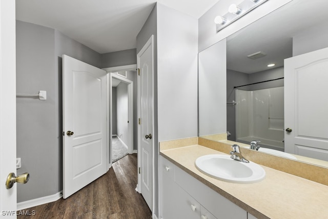 bathroom with vanity, bathtub / shower combination, and hardwood / wood-style flooring