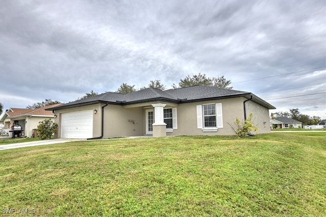 view of front of property with a front yard and a garage