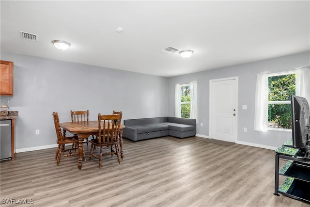 dining space featuring a wealth of natural light and light hardwood / wood-style floors