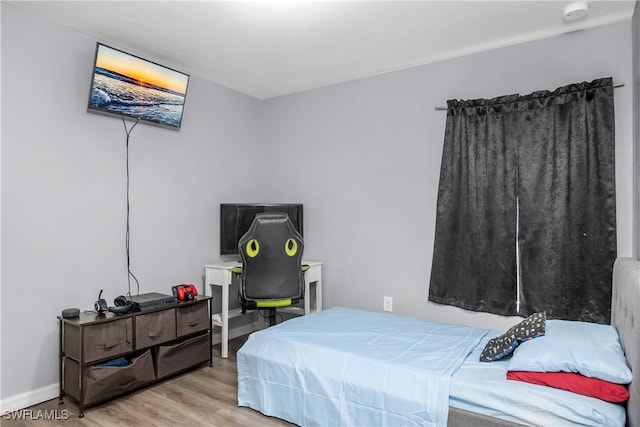 bedroom with hardwood / wood-style floors