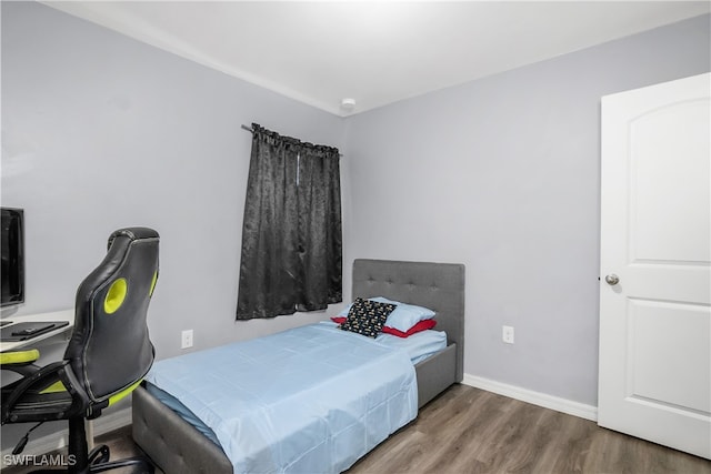 bedroom with hardwood / wood-style floors