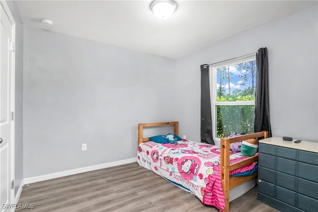 bedroom with dark hardwood / wood-style floors