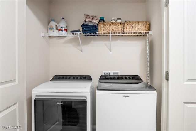 washroom with washing machine and clothes dryer