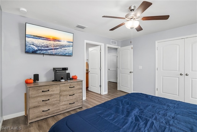 bedroom featuring hardwood / wood-style flooring, ceiling fan, and a closet