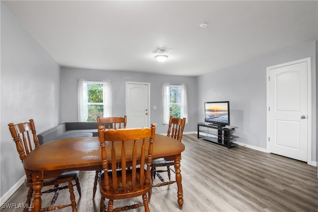 dining space featuring hardwood / wood-style flooring and a healthy amount of sunlight