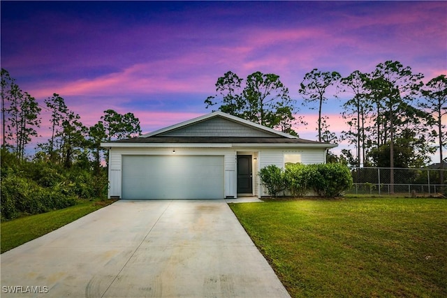 view of front of home featuring a garage and a yard