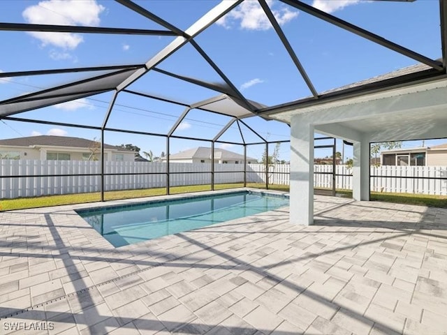 view of swimming pool with a patio and a lanai