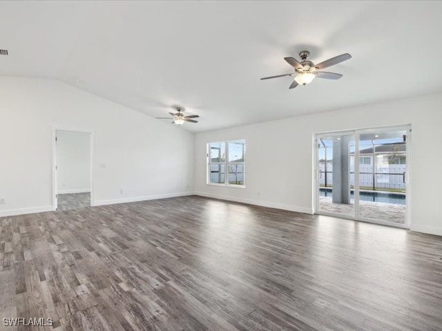 empty room with ceiling fan, hardwood / wood-style flooring, and vaulted ceiling