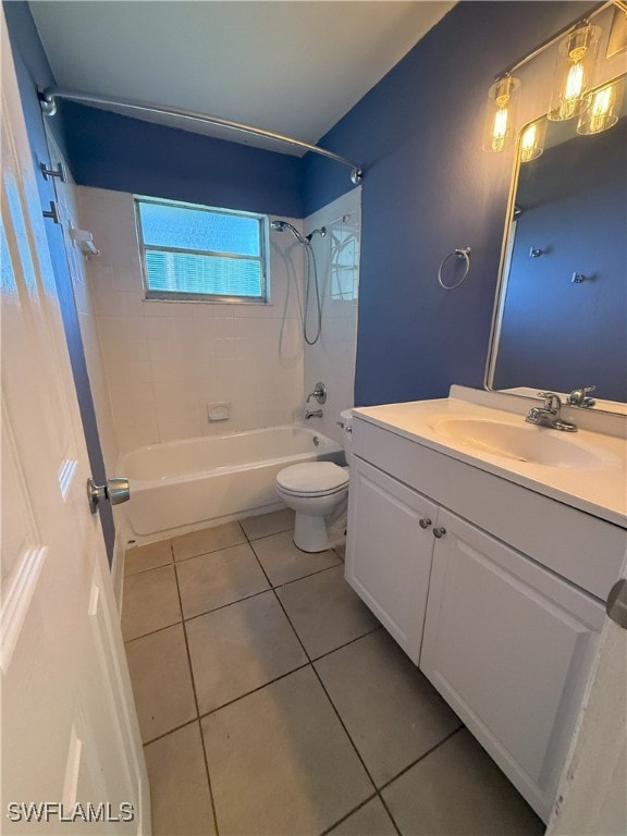 full bathroom featuring toilet, tiled shower / bath, vanity, and tile patterned floors