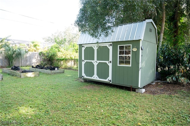 view of outbuilding featuring a lawn