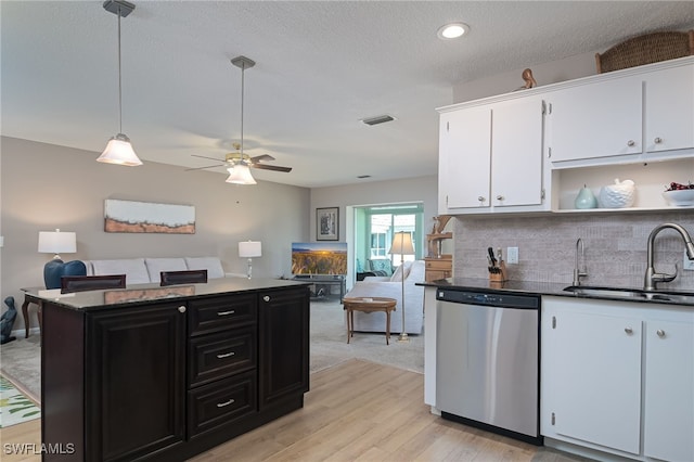 kitchen featuring dishwasher, sink, pendant lighting, light wood-type flooring, and white cabinetry