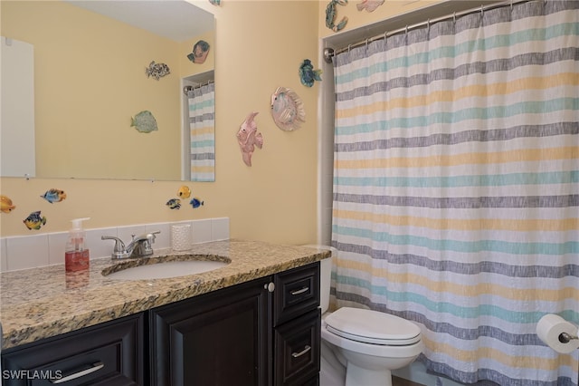 bathroom with vanity, toilet, and walk in shower