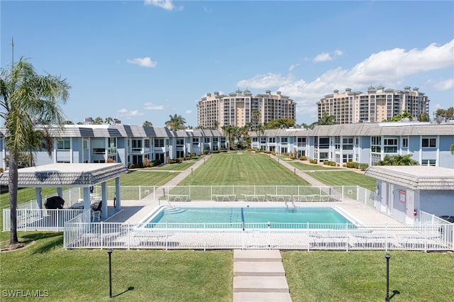 view of swimming pool with a yard and a patio area