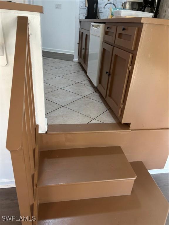 stairs featuring tile patterned flooring