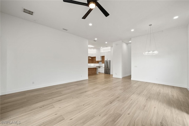 unfurnished living room with light hardwood / wood-style floors and ceiling fan