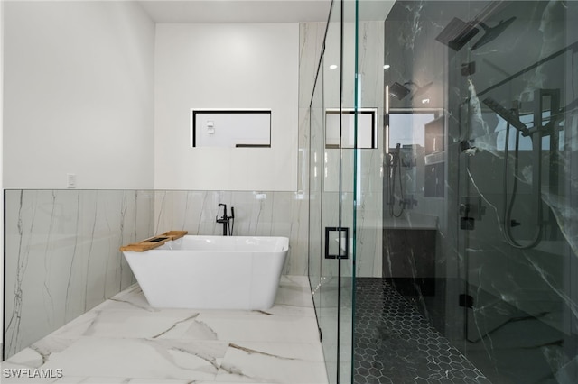 bathroom featuring independent shower and bath and tile walls