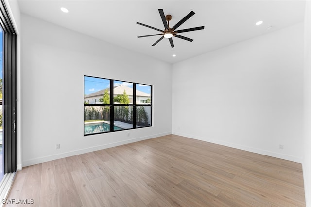 spare room with light wood-type flooring and ceiling fan