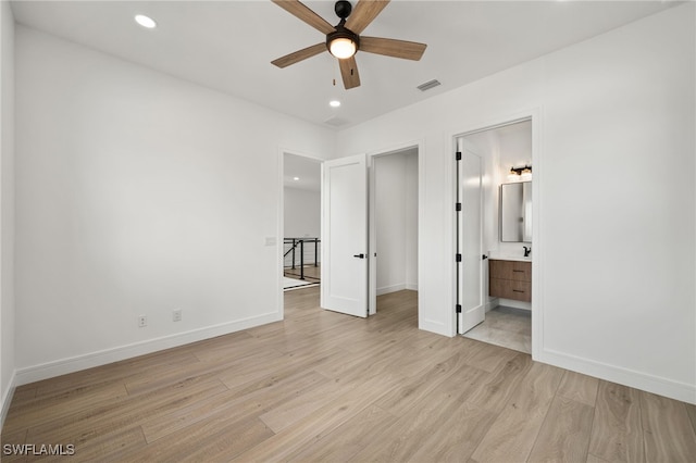 unfurnished bedroom featuring ceiling fan, light hardwood / wood-style flooring, and ensuite bath