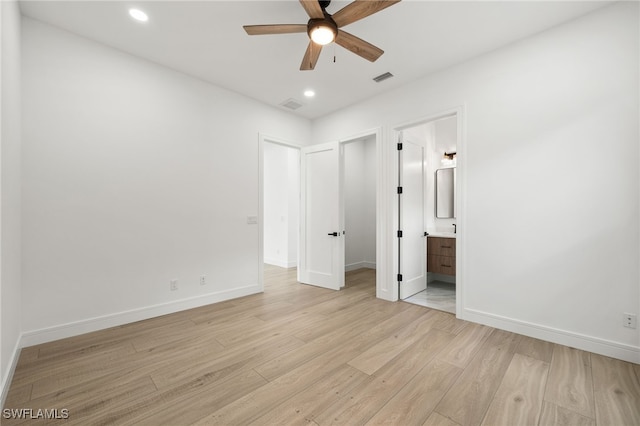 unfurnished bedroom with ensuite bath, ceiling fan, and light wood-type flooring