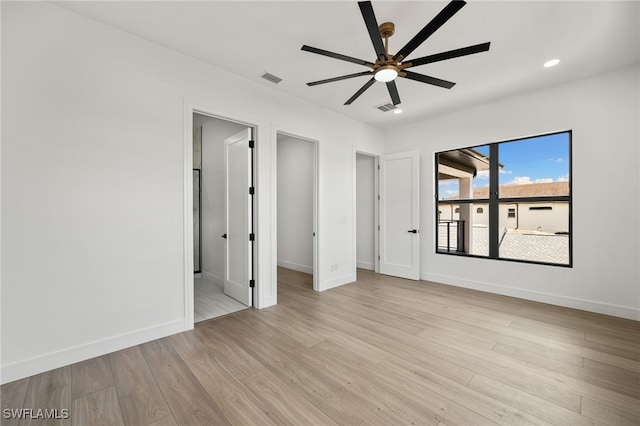 spare room featuring light hardwood / wood-style flooring and ceiling fan