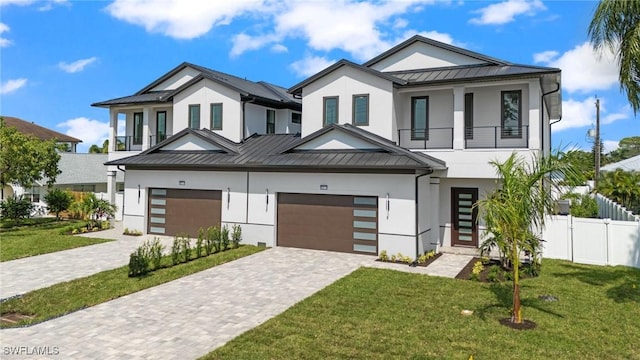 view of front of house featuring a garage and a front lawn