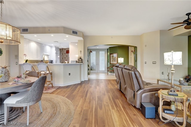 dining space featuring french doors, light hardwood / wood-style floors, and ceiling fan