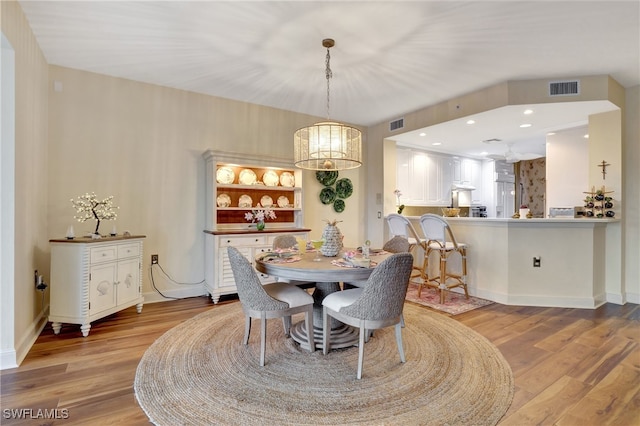 dining space with light hardwood / wood-style floors