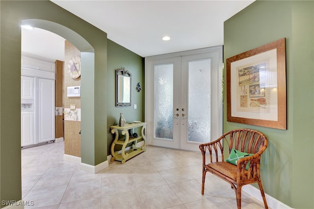 tiled entryway featuring french doors