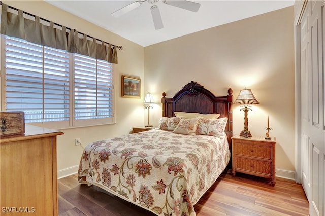 bedroom with a closet, ceiling fan, and hardwood / wood-style flooring