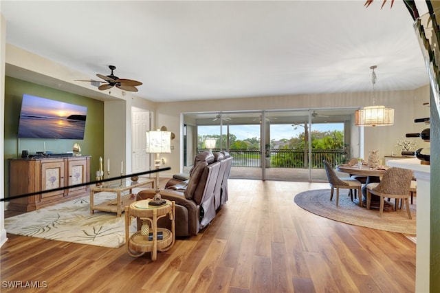 living room featuring light hardwood / wood-style floors and ceiling fan