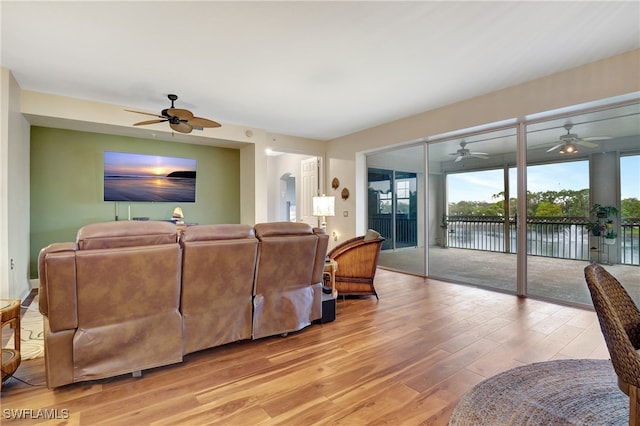 living room featuring light hardwood / wood-style flooring and a water view