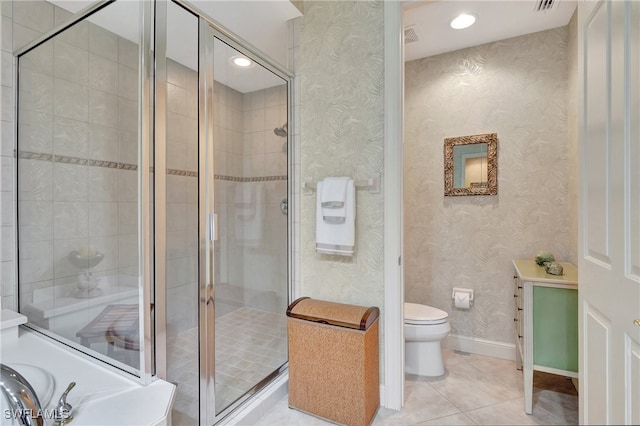 bathroom with toilet, tile patterned floors, and walk in shower