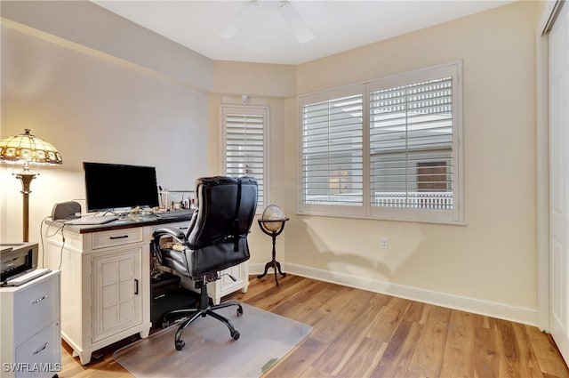 office area with light hardwood / wood-style floors and ceiling fan